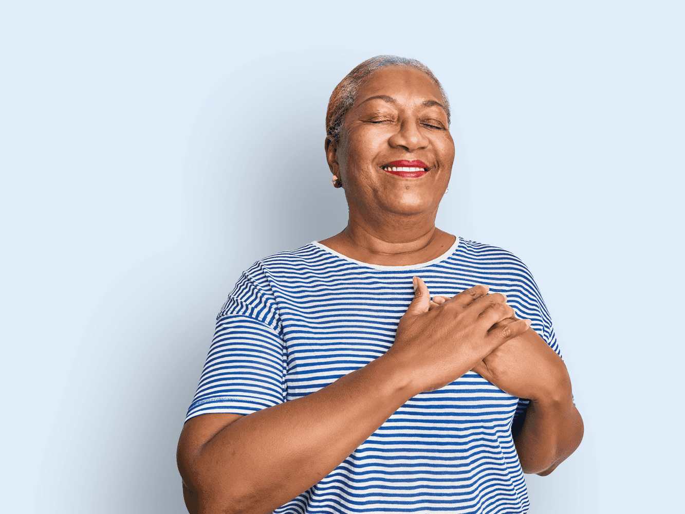 Woman holding hands over her heart.