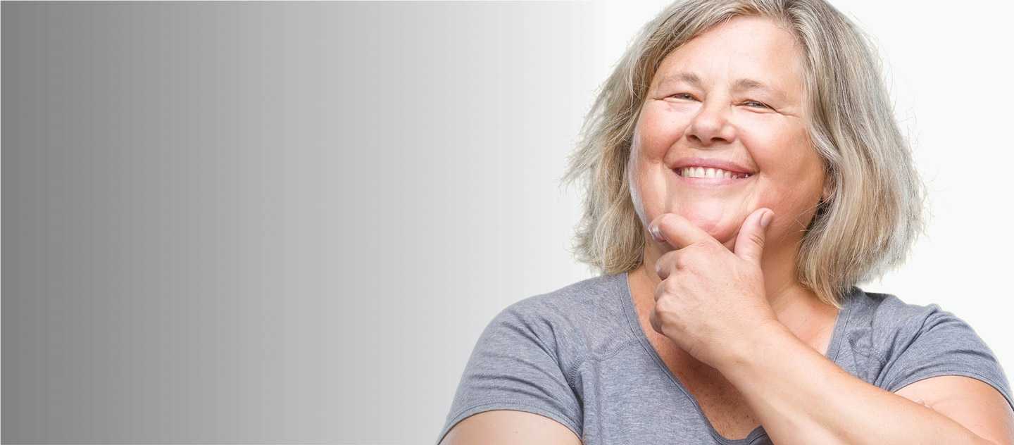 Woman smiling while holding her chin