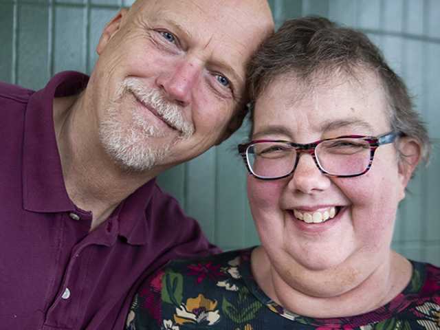 Man and woman next to each other smiling