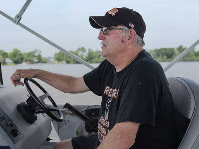 Man driving boat.