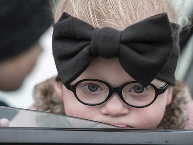 Young girl, wearing glasses.
