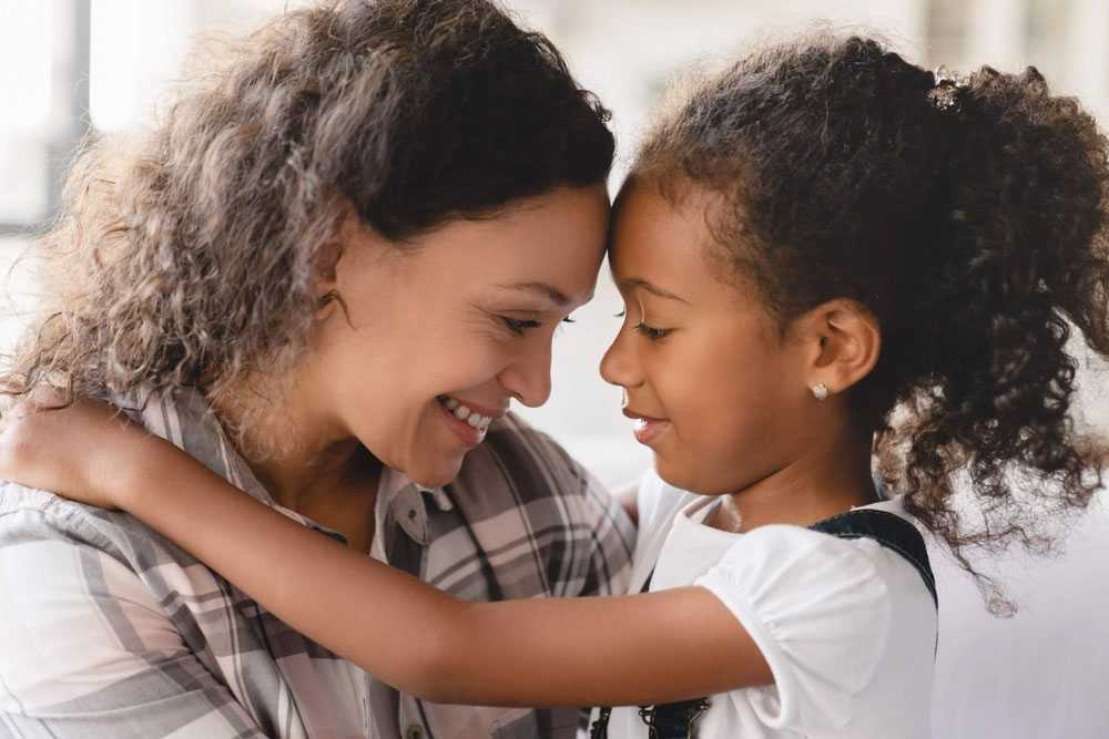 Mother hugging daughter