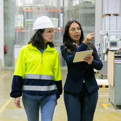 Two women walking through warehouse