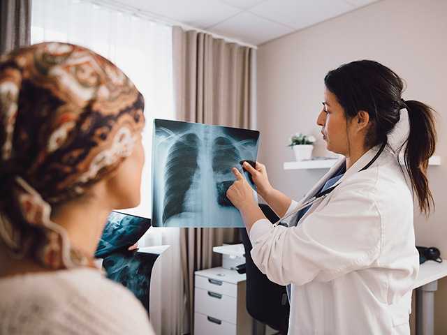 Provider and patient looking at xray