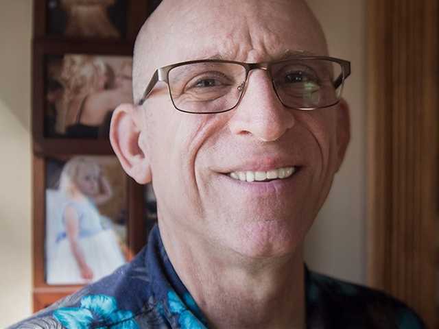 Older gentleman smiling in his home